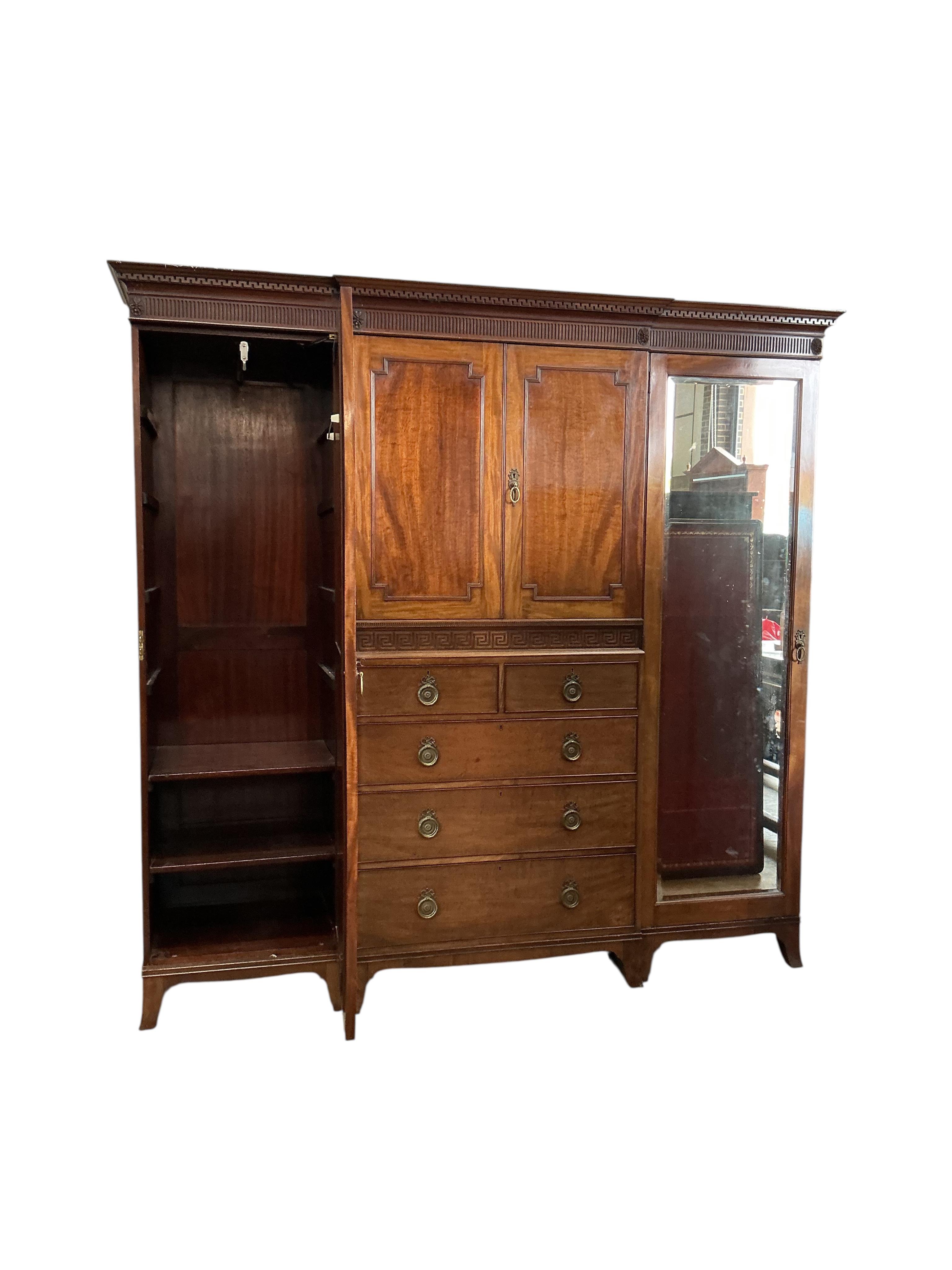 An early 20th century Heal & Son mahogany mirrored compactum wardrobe, width 224cm, depth 58cm, height 215cm